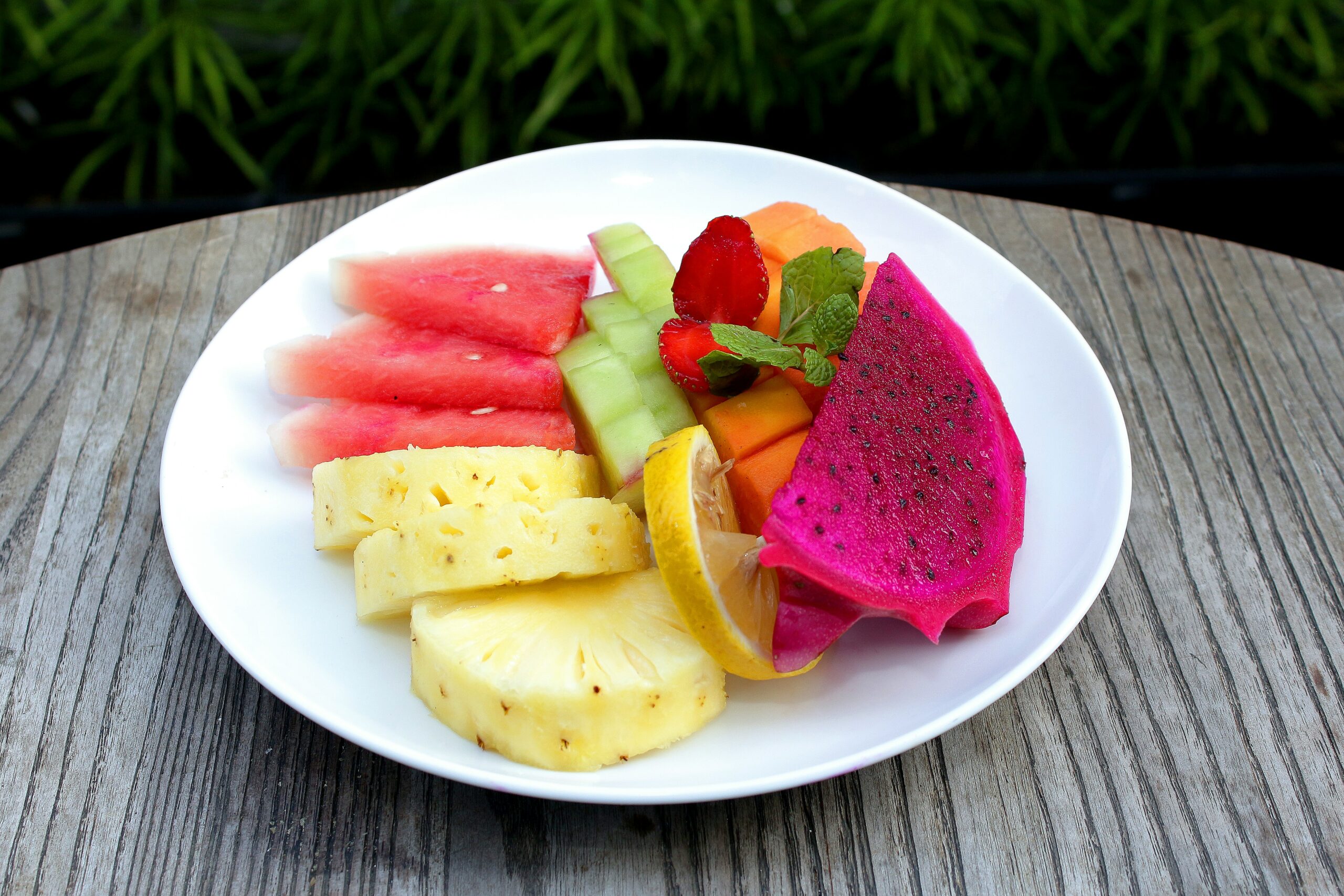 a white plate topped with cut up fruit